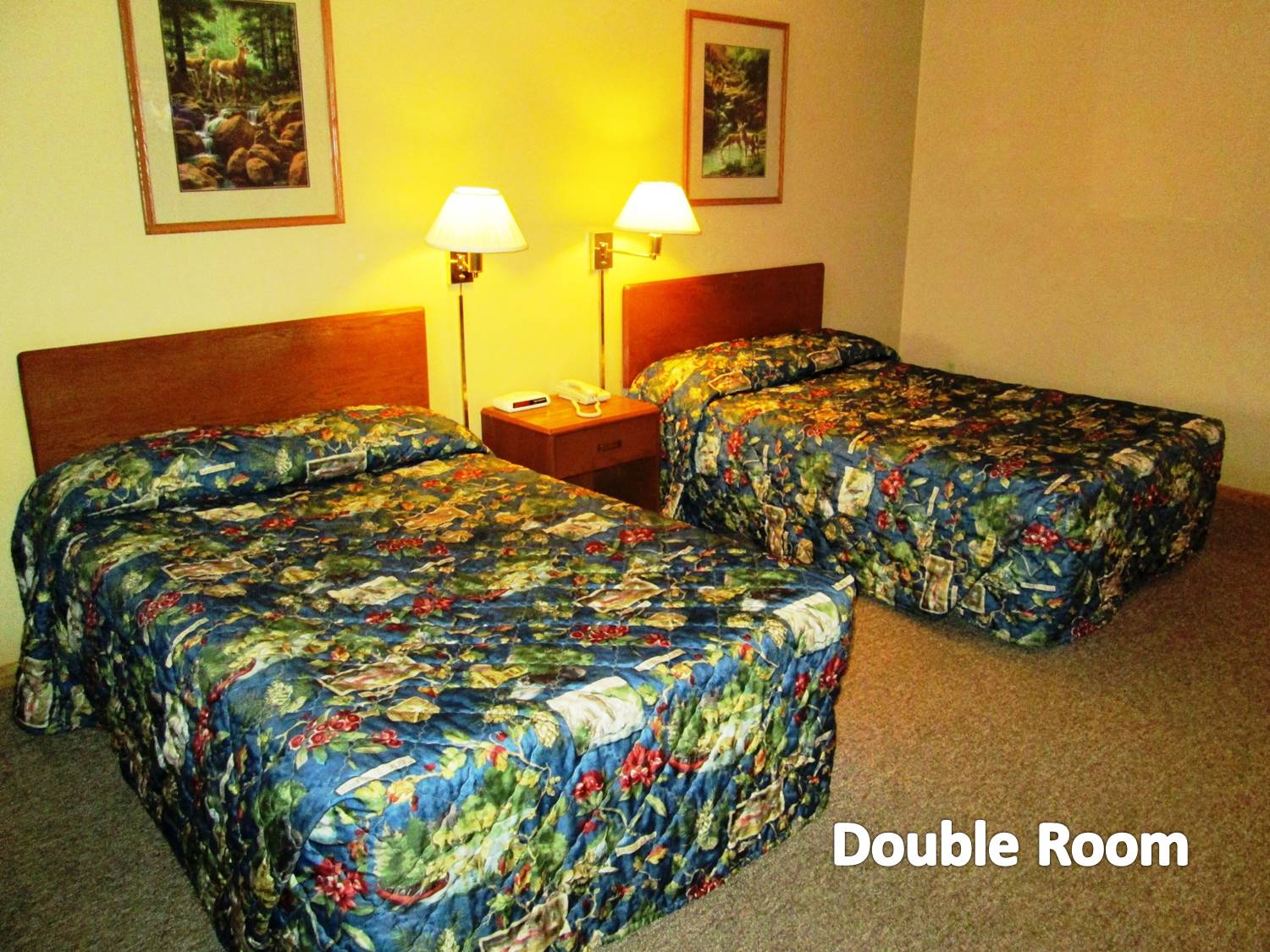 Room with two full-size beds and appropriate furnishings.